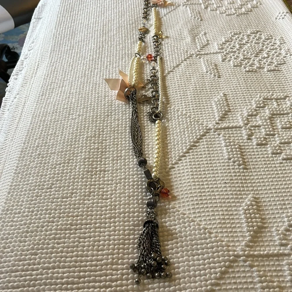 Women’s double chain belt. One of metal objects and the second chain of pearls.